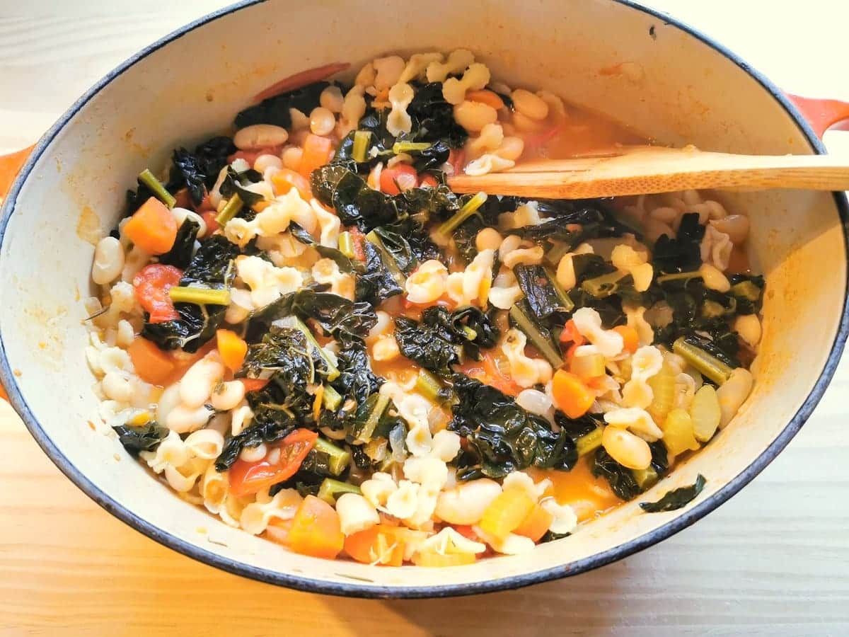 Tuscan kale white bean and past soup in Dutch oven