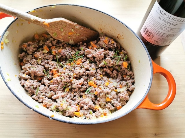 meat and vegetables cooking in Dutch oven