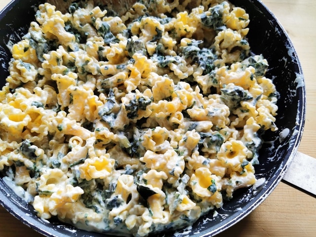 cooked gigli pasta mixed with Swiss chard and ricotta in skillet