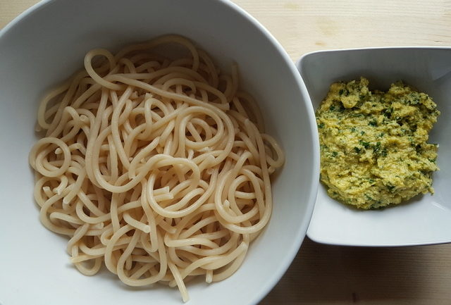 Tuscan pici pasta all'etrusca cooked pasta in white bowl and sauce in white bowl