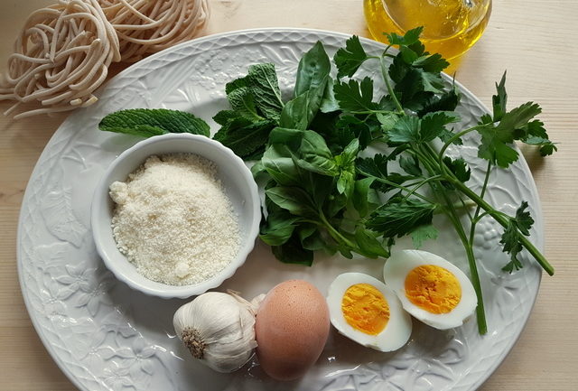 Tuscan pici pasta all'etrusca ingredients on a white plate