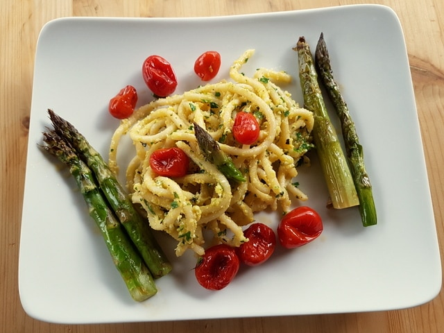 Tuscan pici pasta all'etrusca with roasted asparagus and cherry tomatoes
