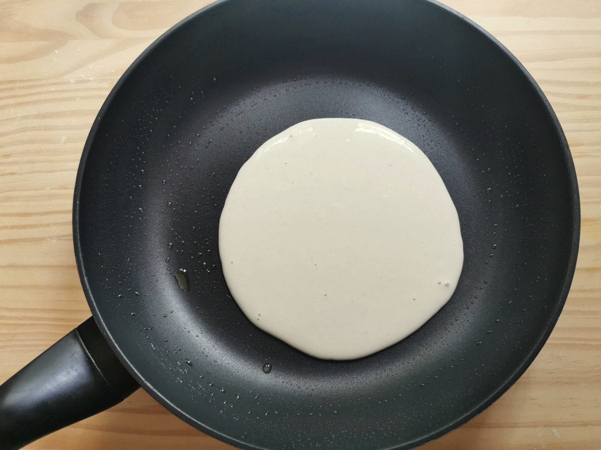 Step 2. A ladleful of testaroli batter in the middle of a hot skillet.