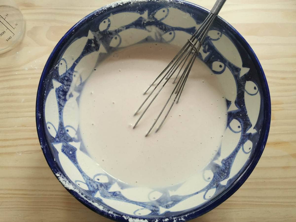 Ready testaroli batter in large bowl with whick.
