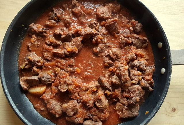 Tuscan wild boar ragu in a frying pan