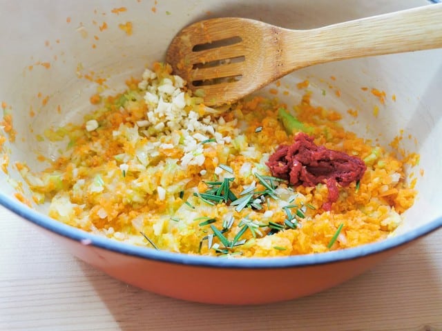 chopped celery, carrots, onions, garlic and rosemary with tomato paste in Dutch oven