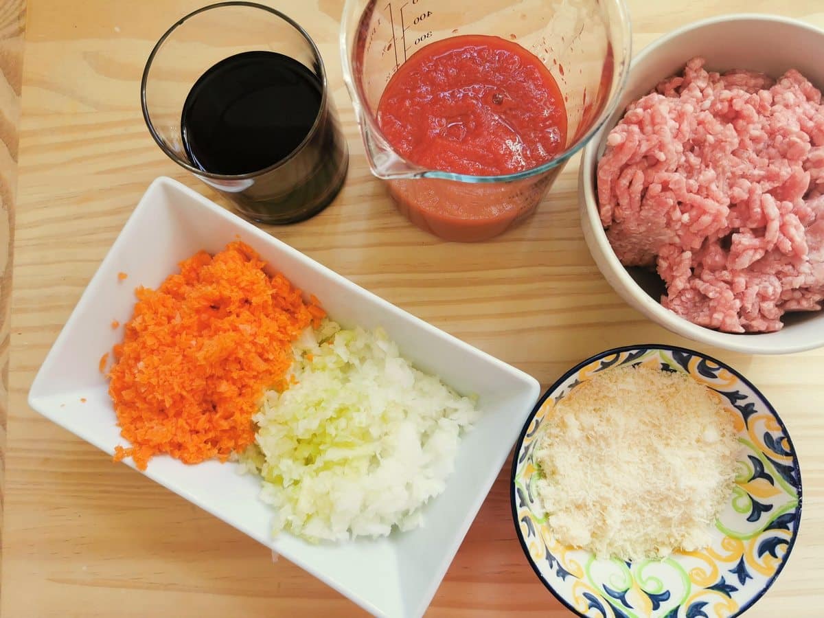 Prepared ingredients for veal ragu. Ground veal, finely chopped onion, celery and carrot, a measure of redwine and a measure of tomato passata.