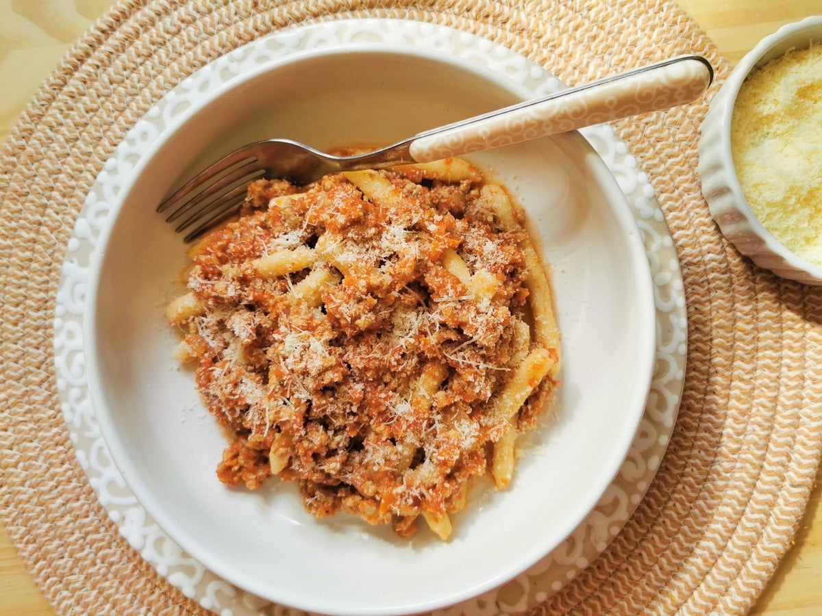 Veal ragu with homemade maccheroni sprinkled with grated Parmigiano cheese.