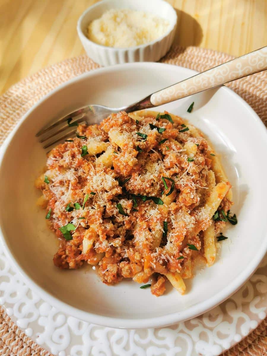 Veal ragu with homemade maccheroni sprinkled with grated Parmigiano cheese and fresh parsley.