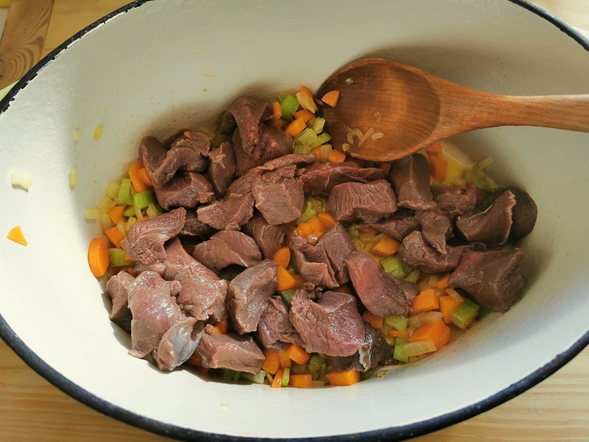 Venison being browned in a pot.