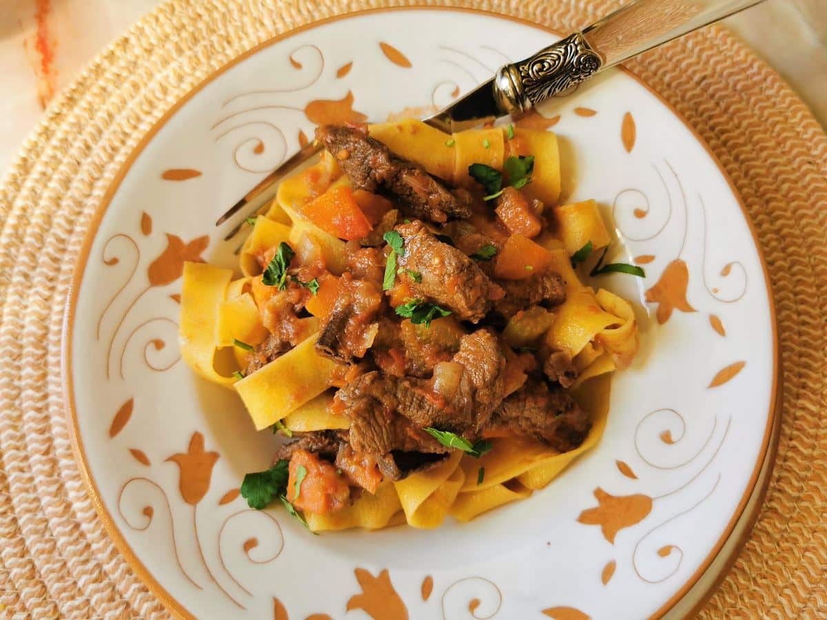 Venison ragu with pappardelle served on a plate.