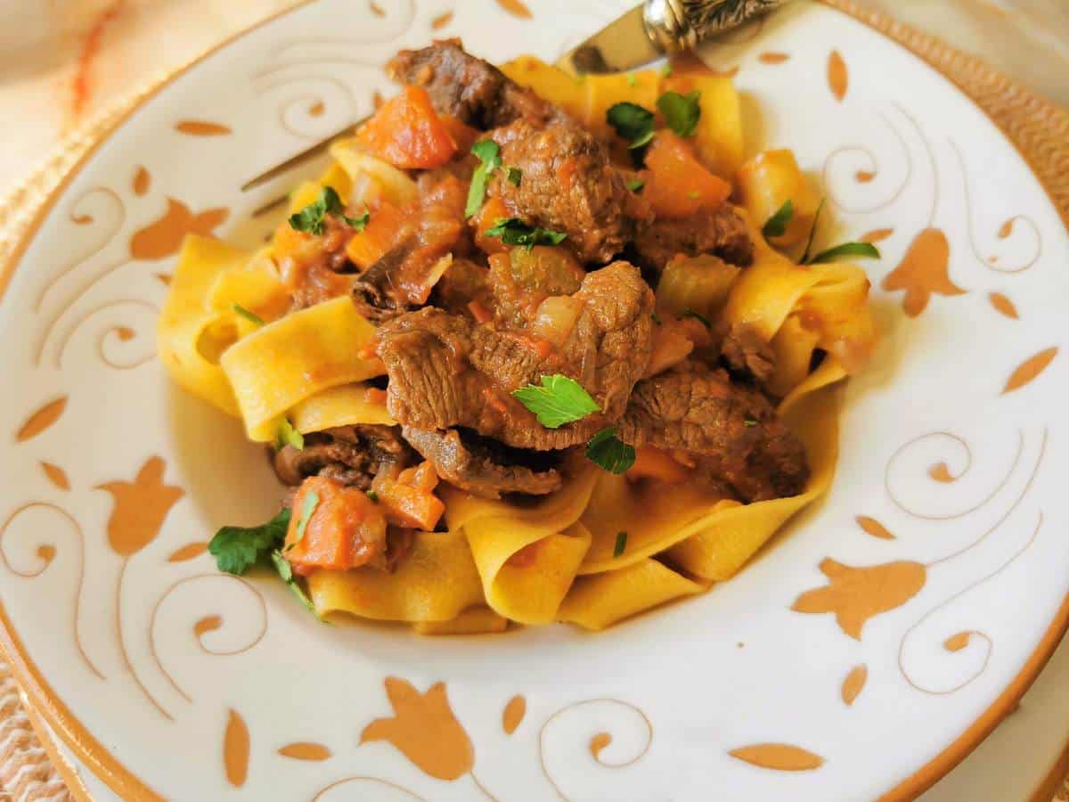 Venison ragu with pappardelle garnished with herbs.