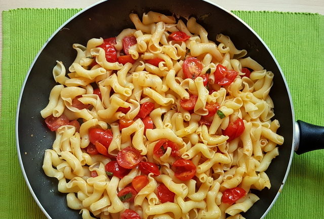 torchio pasta and cherry tomato sauce in frying pan