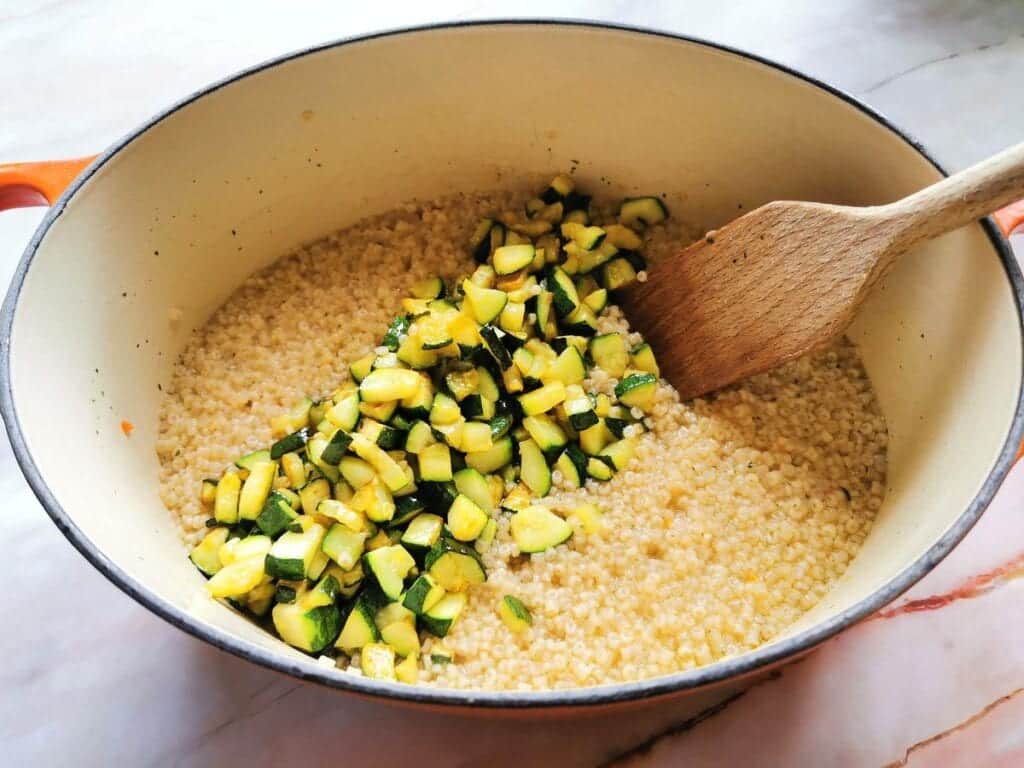 cooked zucchini cubes in Dutch oven with the corallini pasta