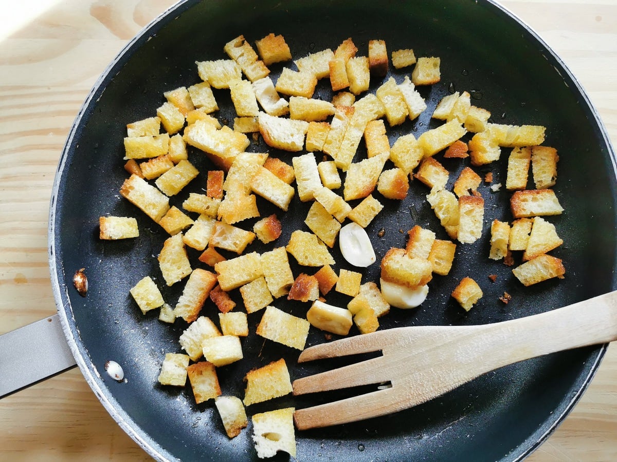 Homemade fried croutons in skillet.