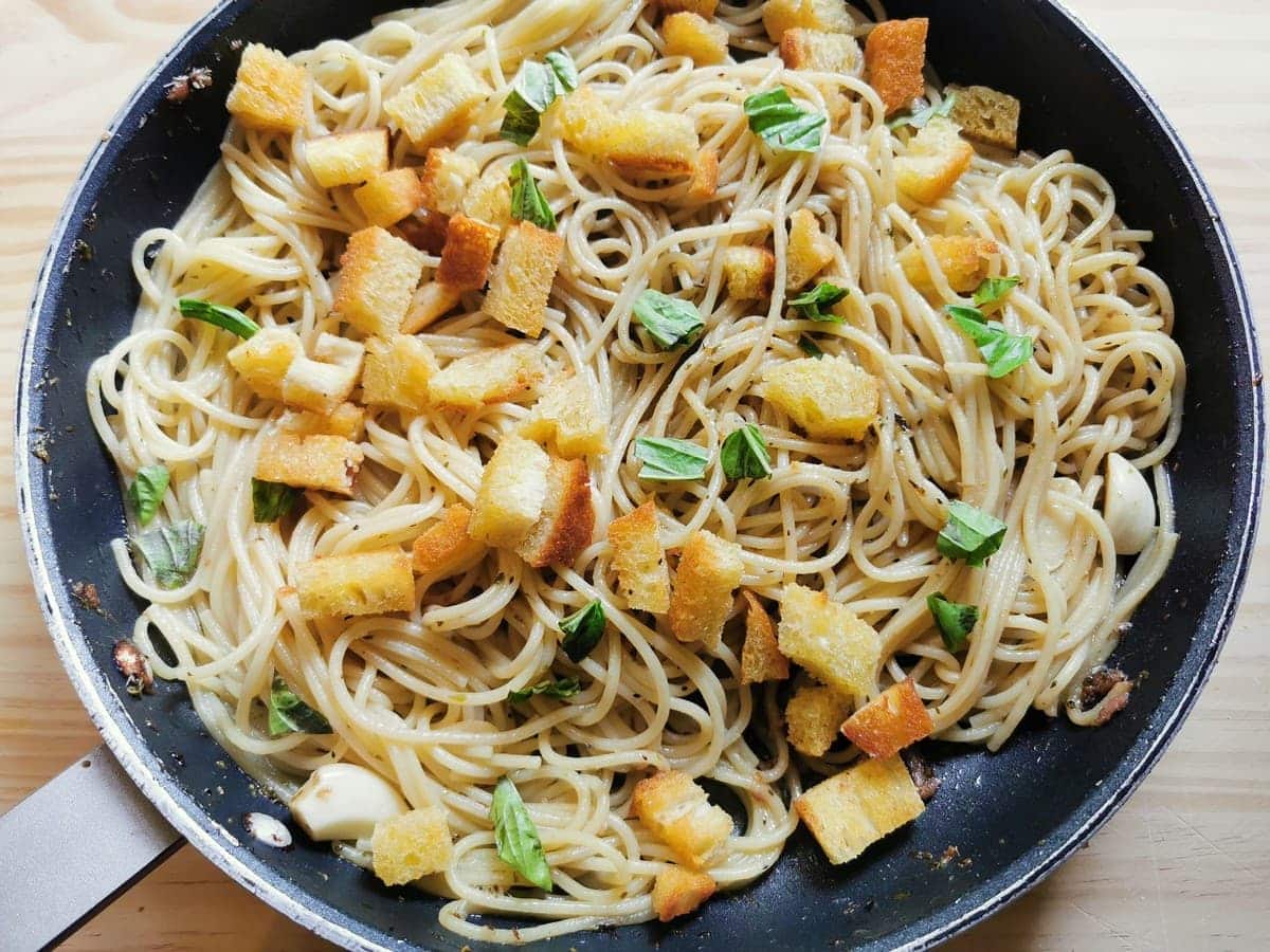 spaghetti alla gennaro anchovy pasta from Naples in skillet ready to be served.