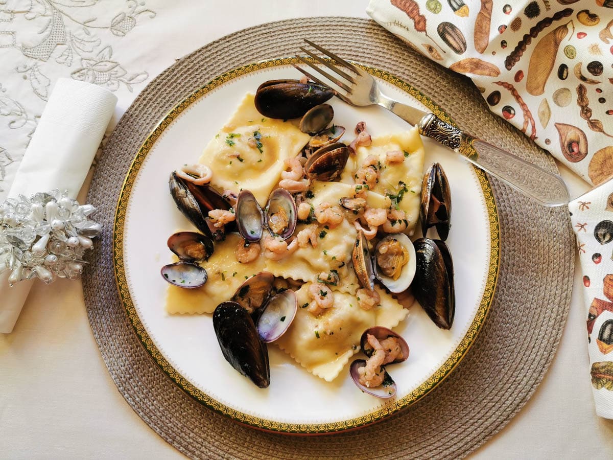 Baked fish ravioli with a seafood sauce.