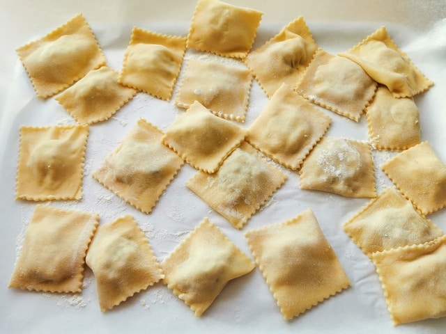 tray of homemade fish ravioli on baking paper