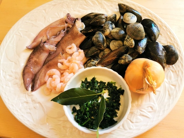 ingredients for the seafood sauce on a white plate