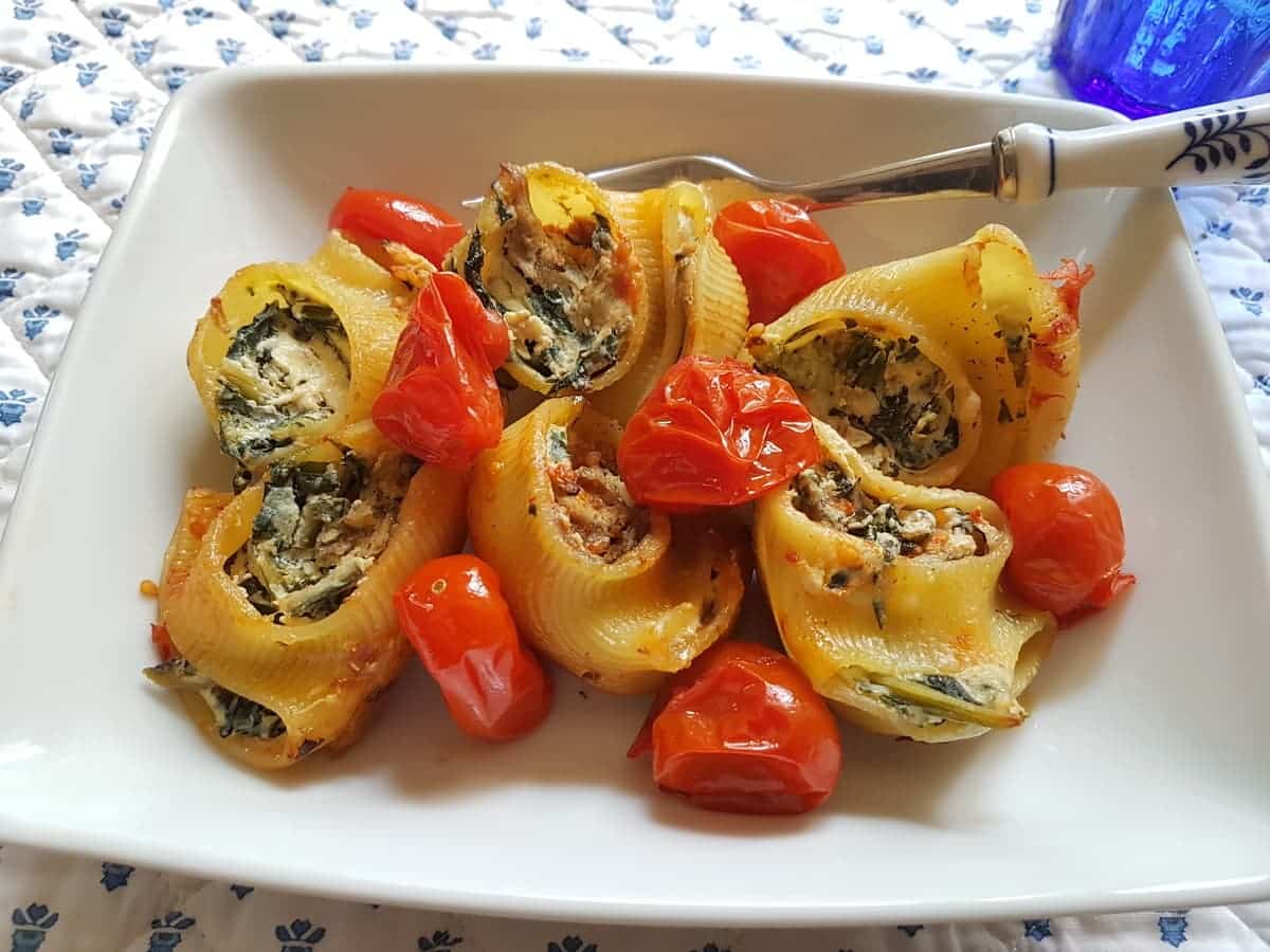 baked lumaconi pasta shells filled with chicory and porcini