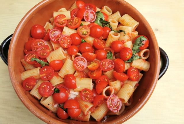 baked pasta alla Tranese in terracotta oven dish before baking