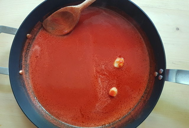 fresh tomato sauce with garlic in deep frying pan