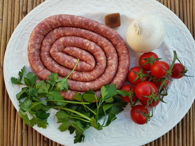 sausage and other ingredients on white plate