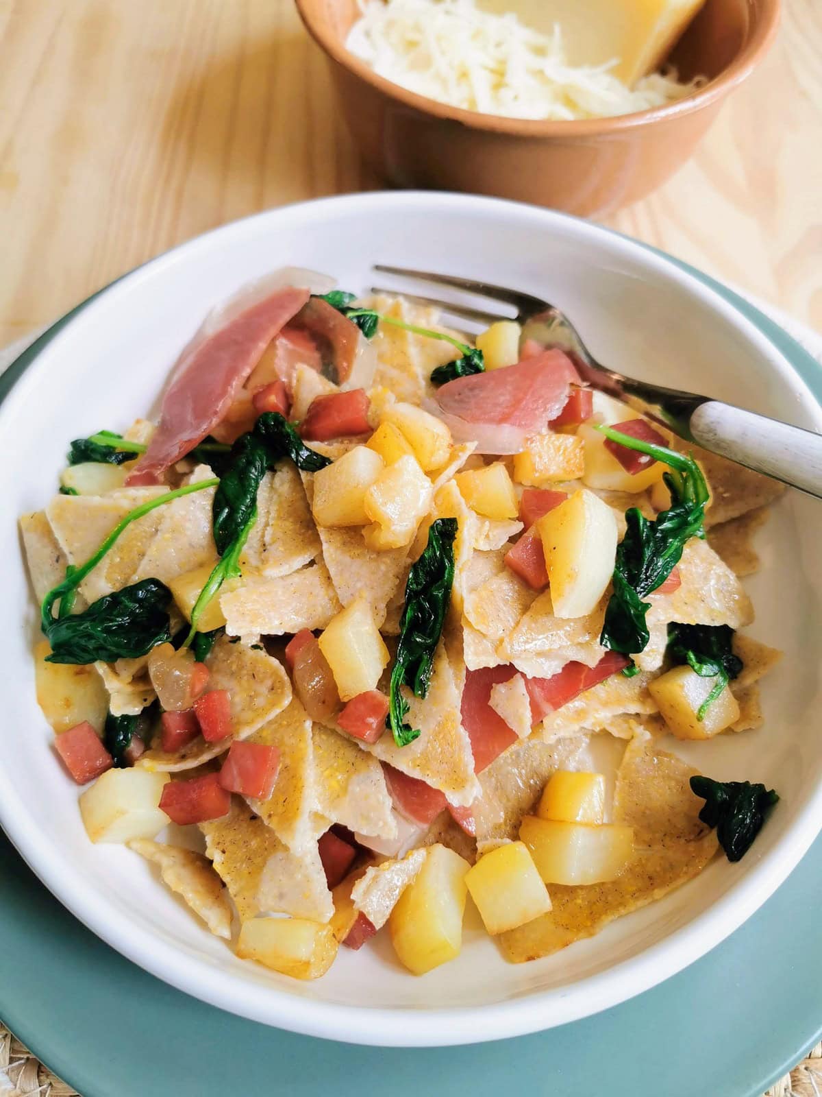Homemade blecs buckwheat pasta with speck and potatoes.