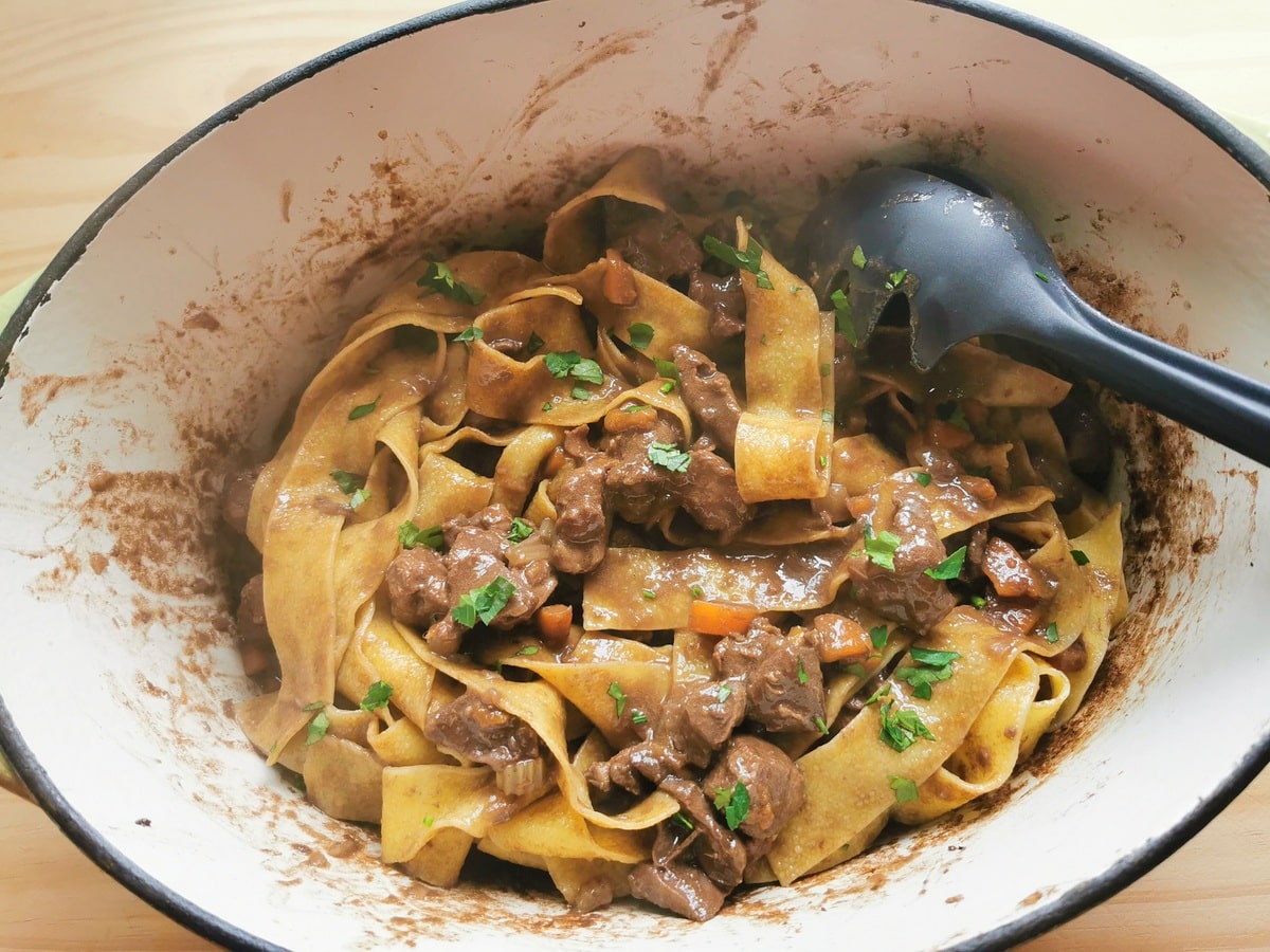 Ready pappardelle with braised hare ragu in Dutch oven.