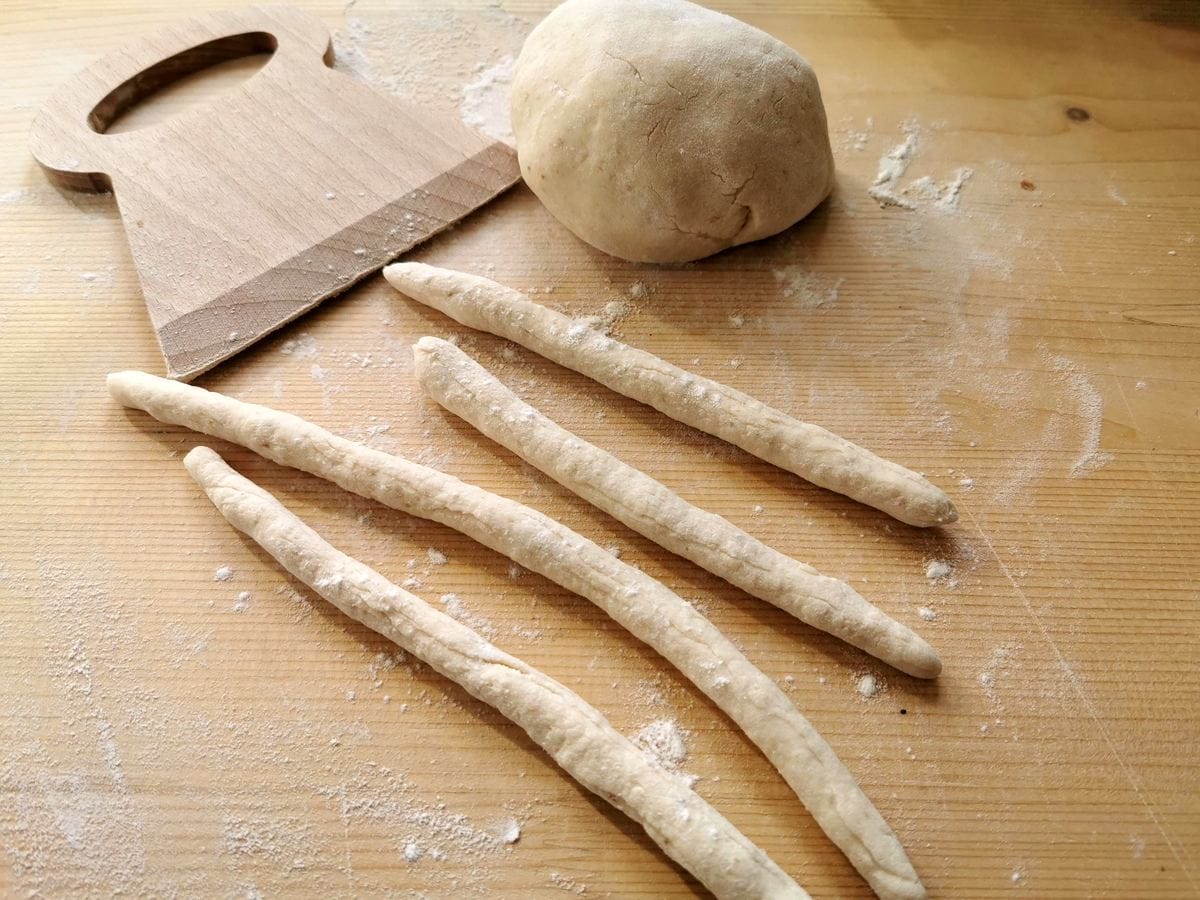 bread gnocchi dough pieces rolled into snakes.