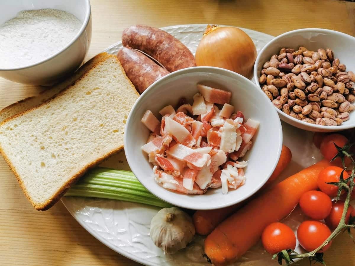 ingredients for bread gnocchi with sausage on plates