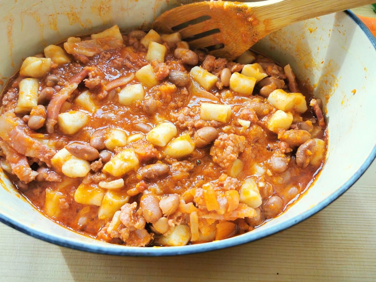 bread gnocchi added to the sausage sauce in the dutch oven