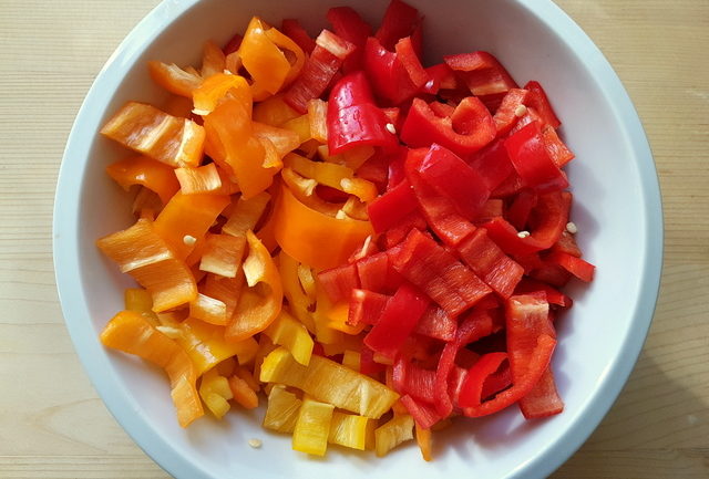 sliced sweet peppers in white bowl