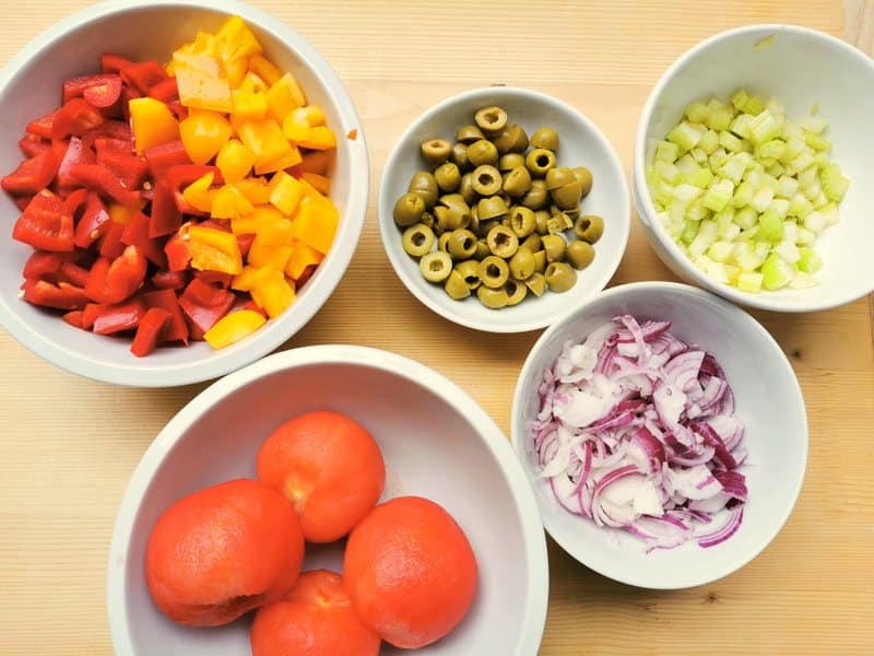 prepared ingredients for caponata in white bowls