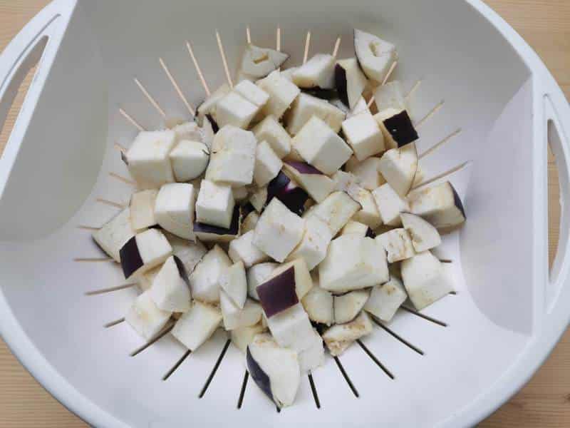 cubed eggplant in colander