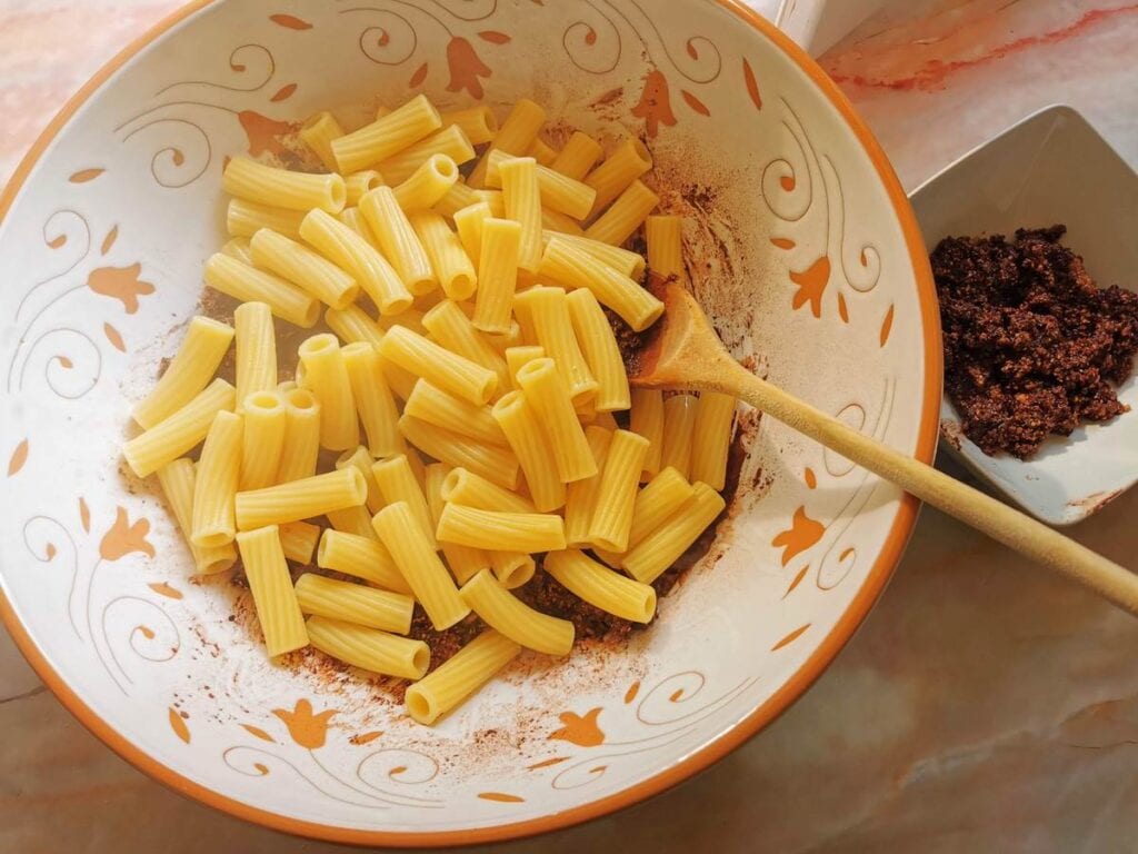 cooked pasta added to the bowl with the chocolate and walnut paste.