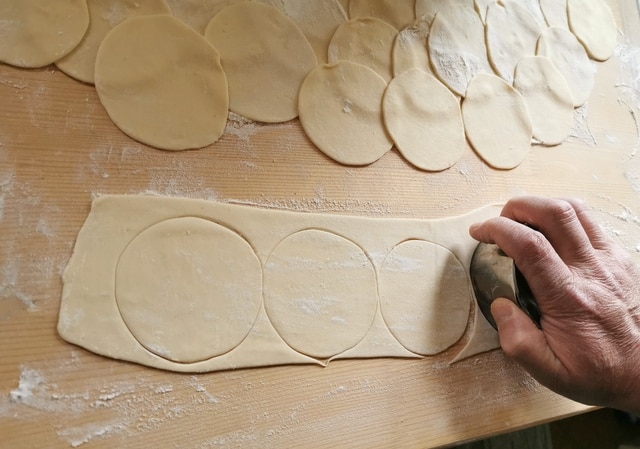 cutting pasta discs from rolled out pasta dough