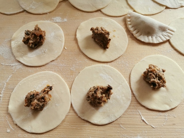 fresh pasta dough discs with prune and fig filling in the centre