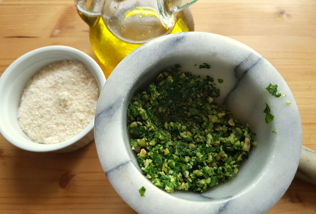 homemade basil pesto in marble mortar