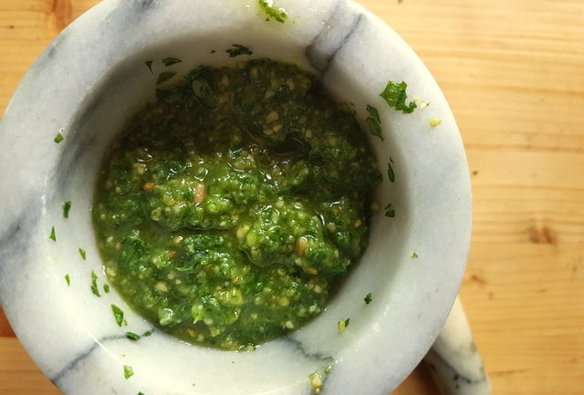 homemade basil pesto in marble mortar