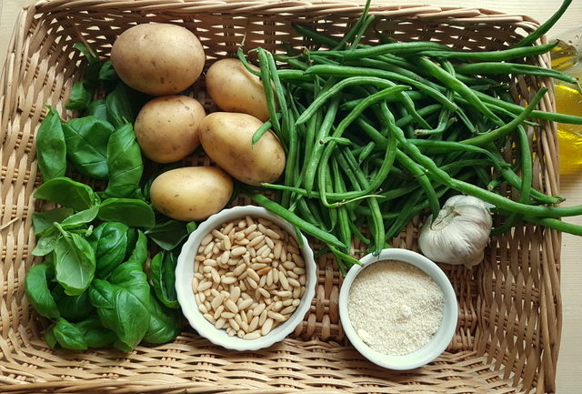 Ingredients in basket for pesto pasta Liguria with potatoes and green beans