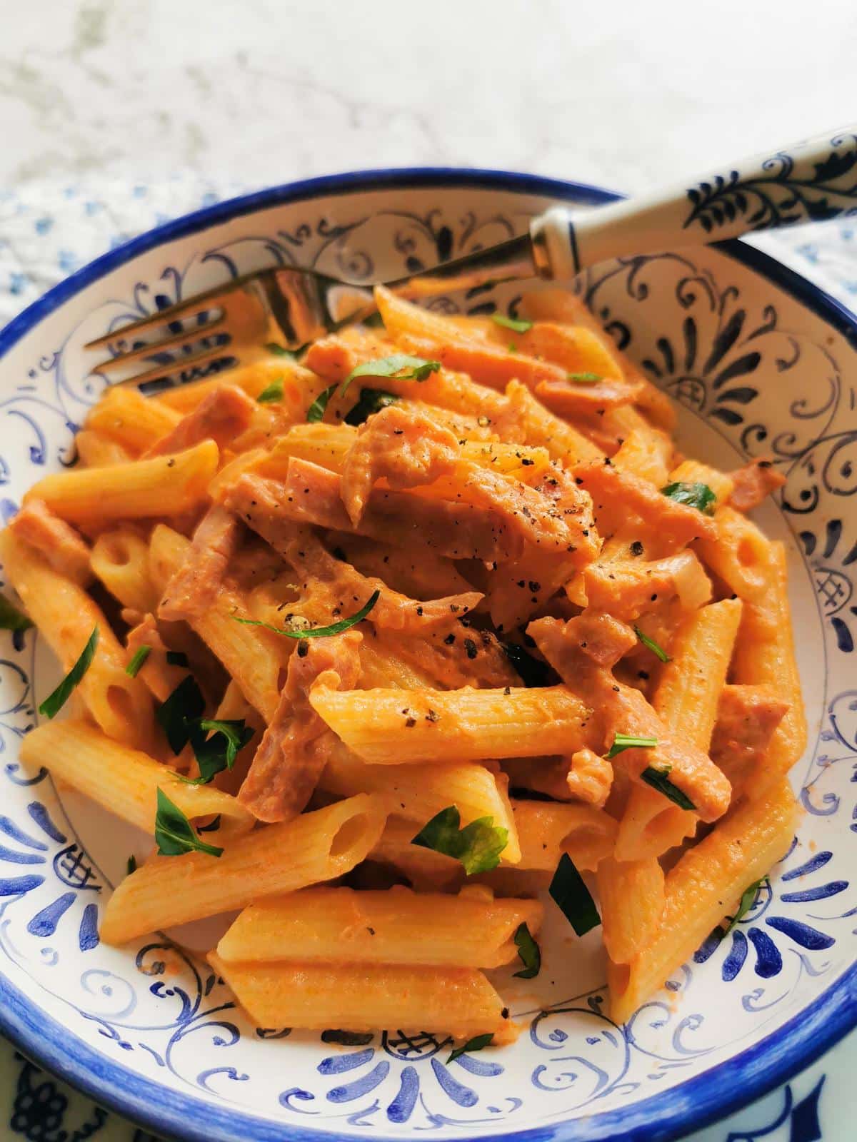 Creamy tomato and ham penne al baffo .