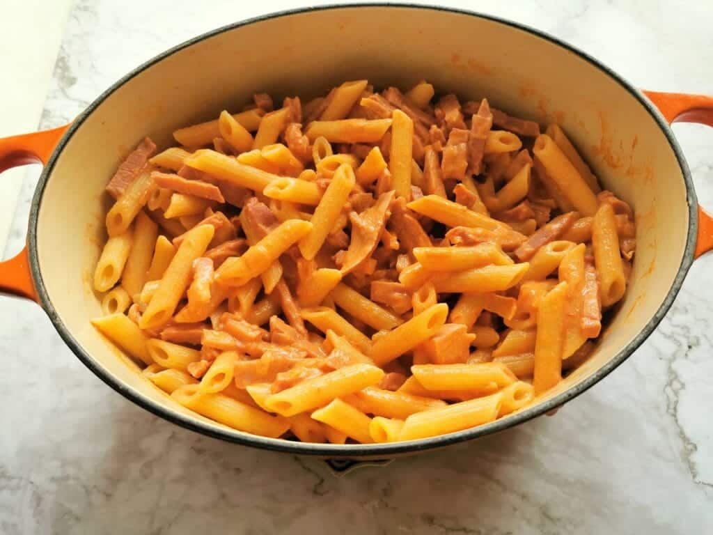 Creamy ham and tomato penne al Baffo in a dutch oven.