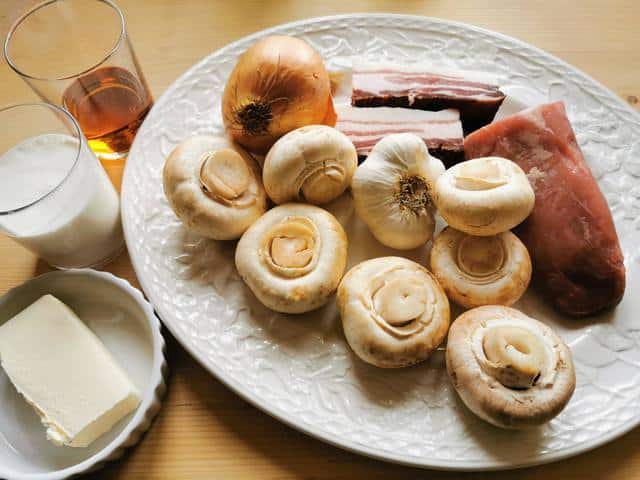 ingredients for pork fillet sauce on white plate