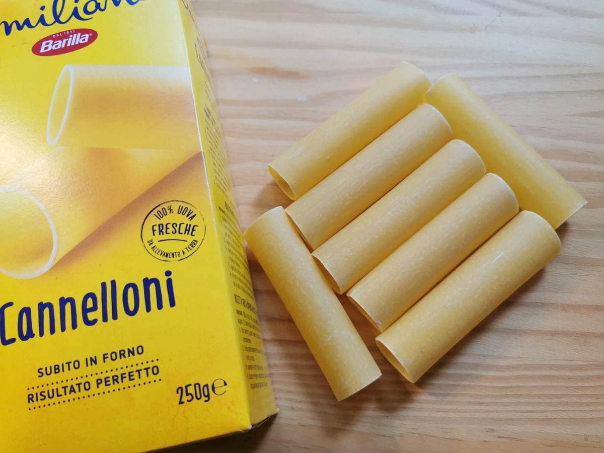 Dried cannelloni tubes from Barilla on wood worktop.
