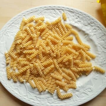 Dried fusilli pasta on a plate.