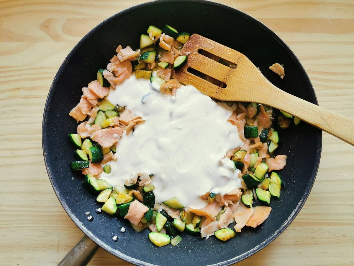 heavy cream added to salmon and zucchini in skillet