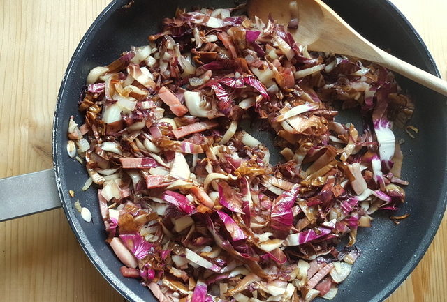 onions, speck and radicchio in frying pan for pasta with speck and radicchio recipe