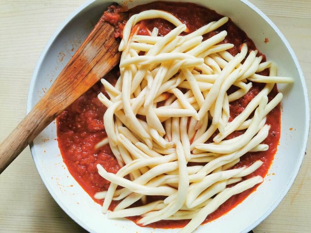 cooked fileja pasta in pan with nduja sauce