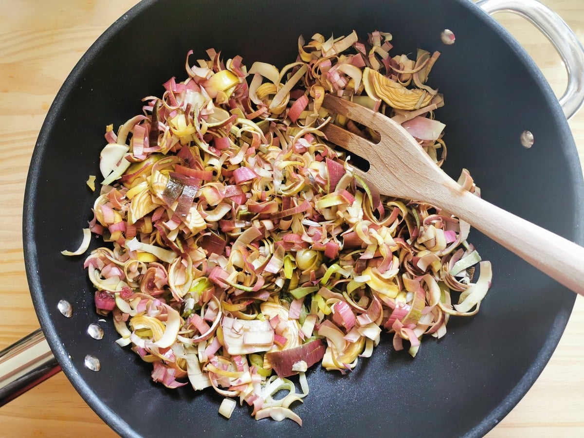 Sliced artichokes in deep frying pan.